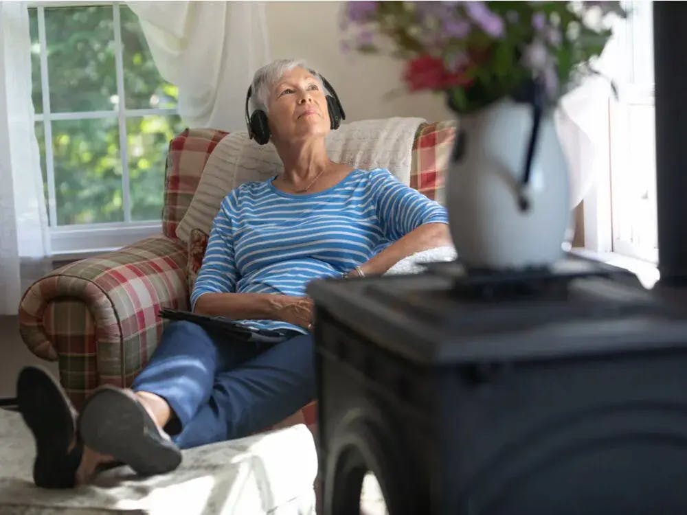 A woman listening to music in an elderly living facility