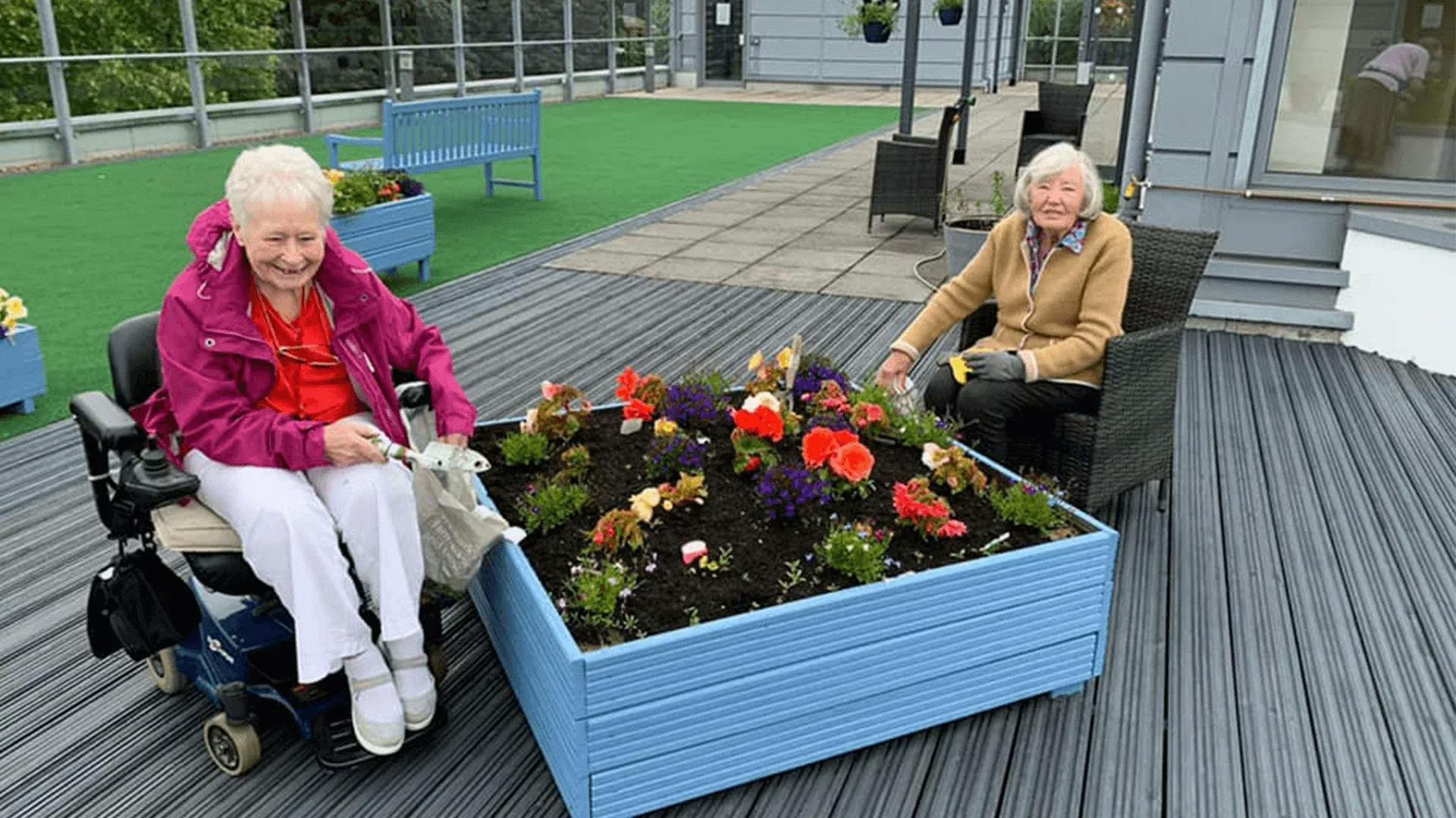 Residents on the decking at Hawthorns Aldridge Care Home in Walsall, Staffordshire