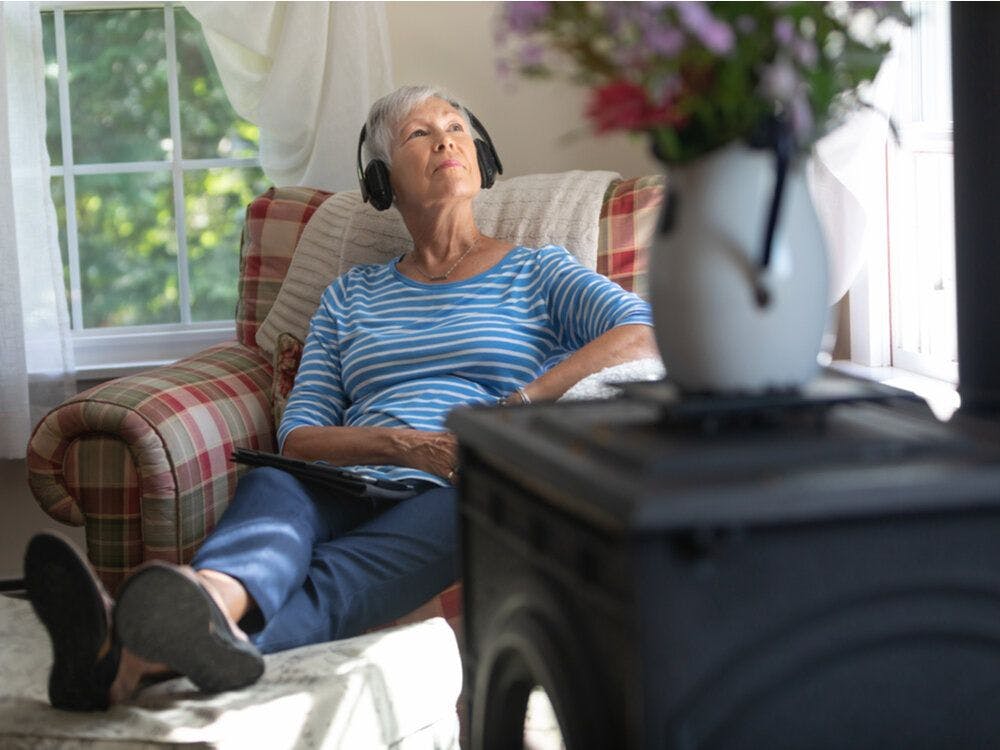 A woman listening to music in an eldelry living facility