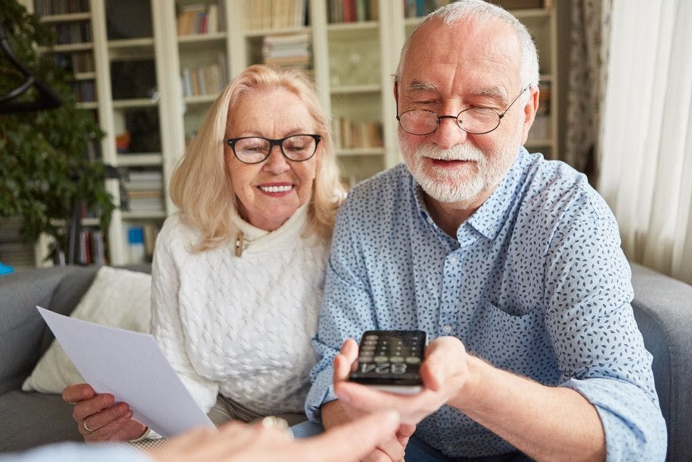 Older couple calculating cost of home care