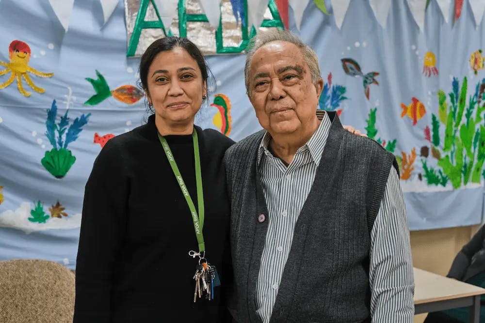 Older man and woman standing together and smiling