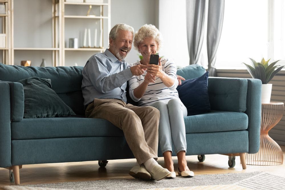 Elderly couple using a phone
