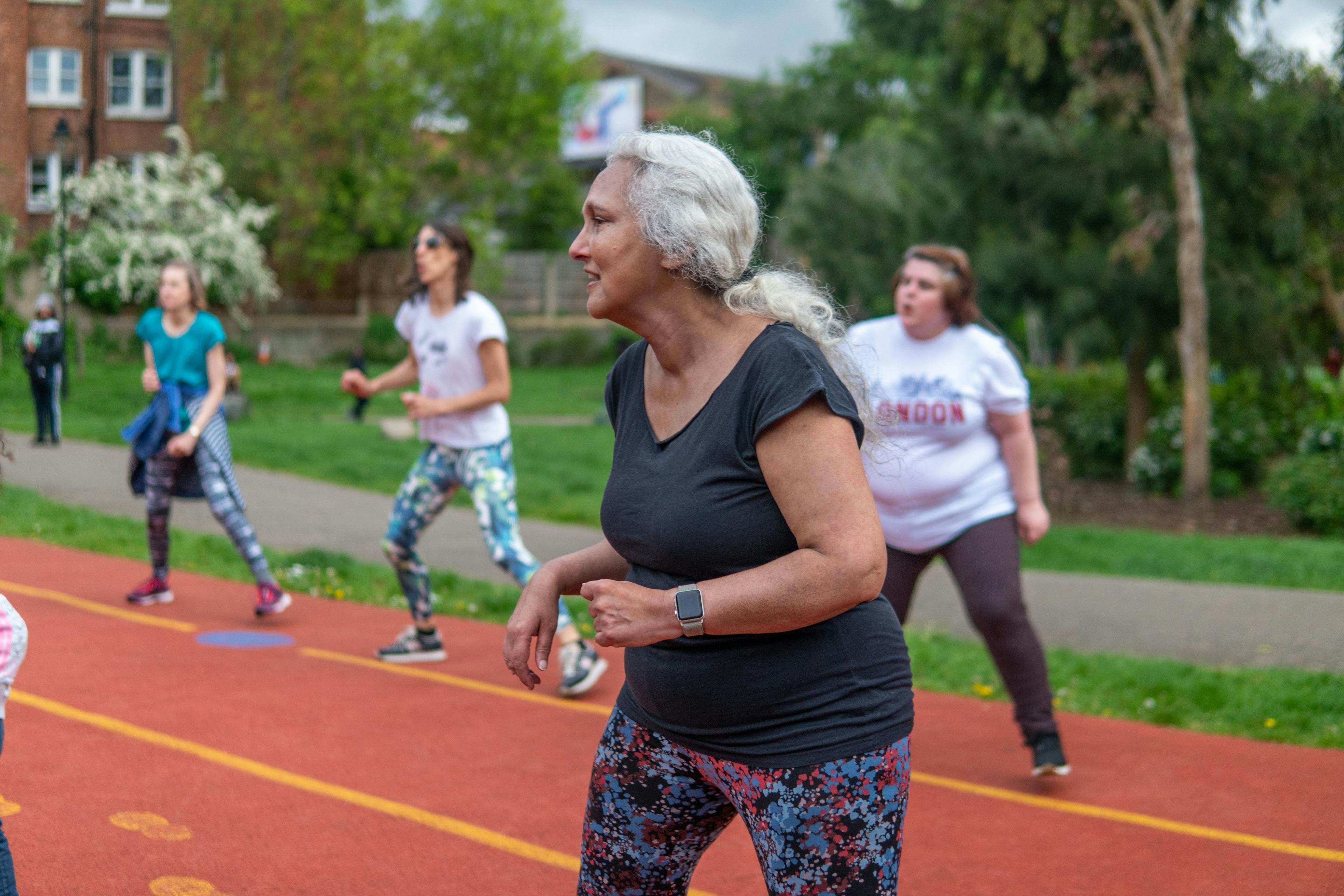 Older woman exercising on an athletics track